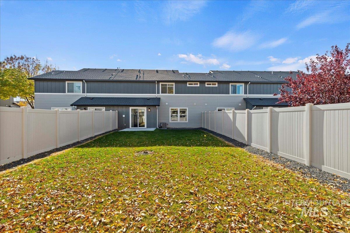 Back of property featuring a fenced backyard and a patio area