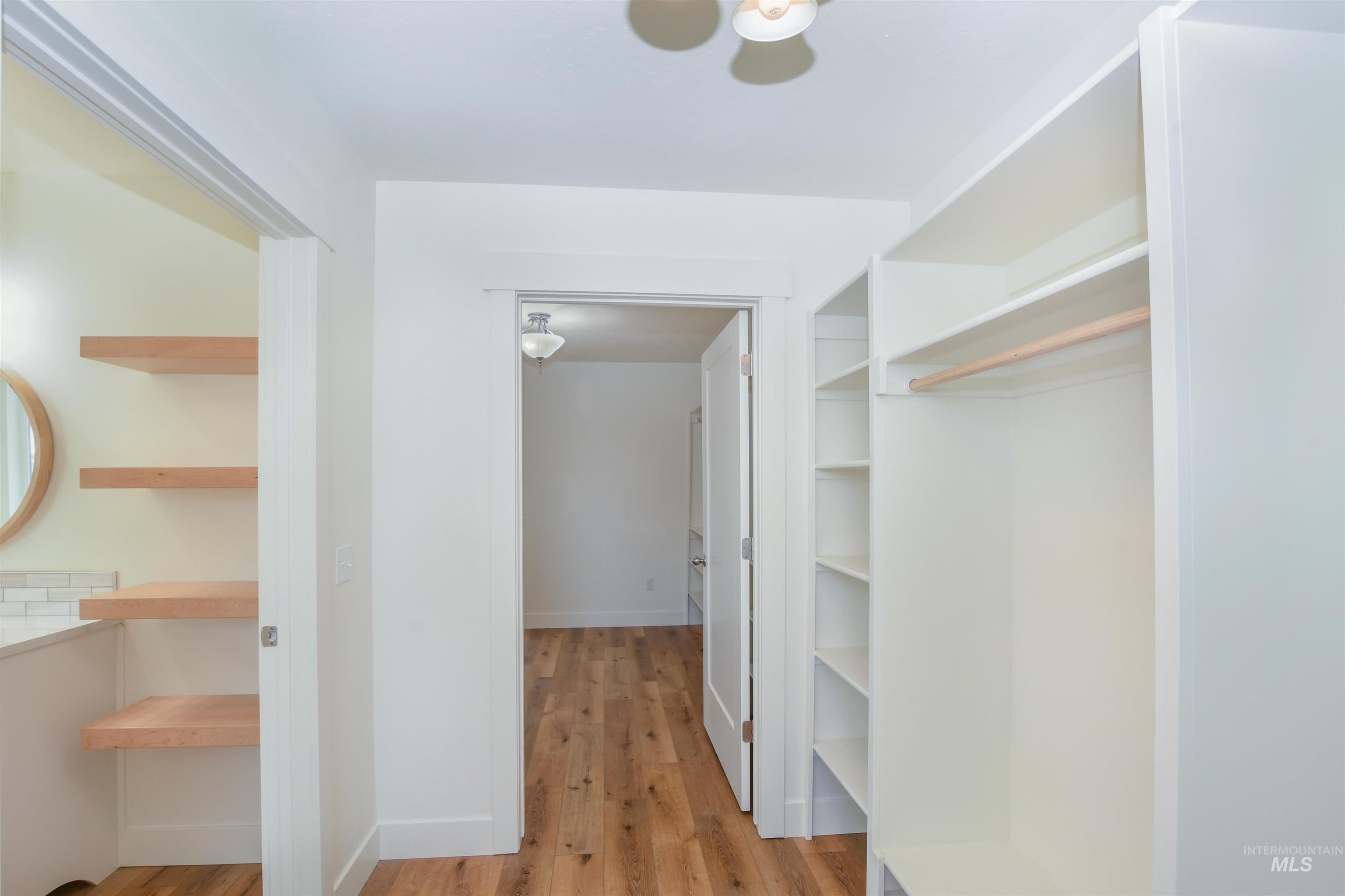 Spacious closet with light wood-style flooring