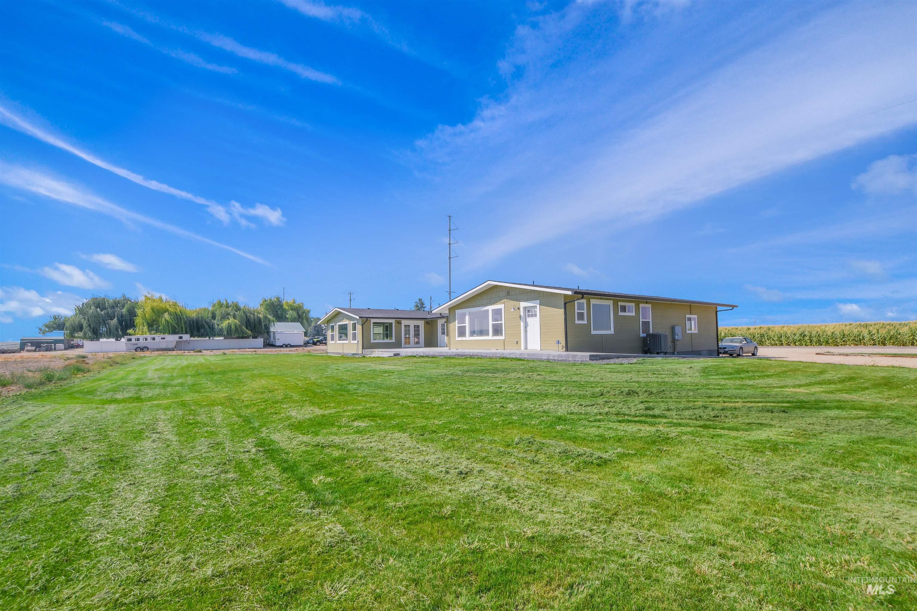 Back of property with a yard