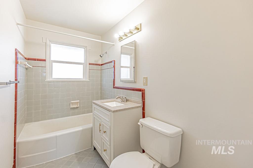 Full bath with vanity, shower / bathtub combination, and light tile patterned floors