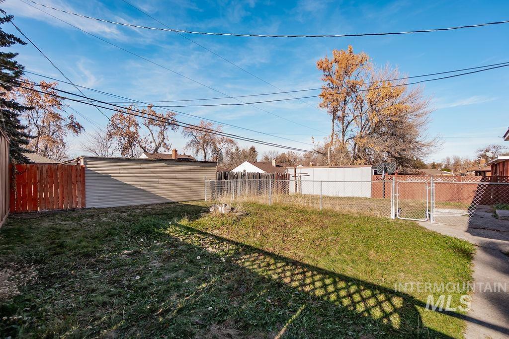 Fenced backyard featuring a gate