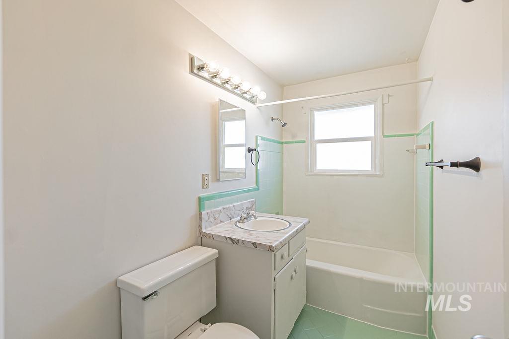 Full bath with vanity, shower / washtub combination, and tile patterned flooring