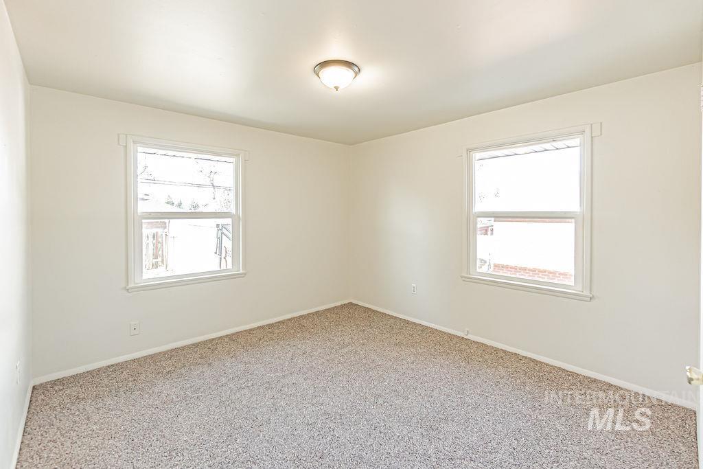 Carpeted empty room with healthy amount of natural light