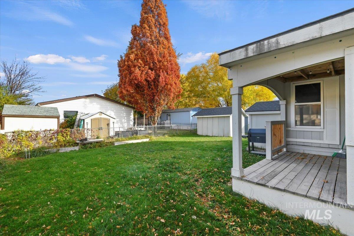 View of yard with a storage unit and a wooden deck