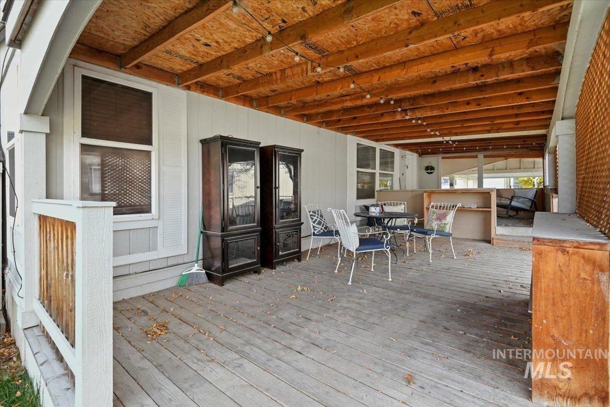 Wooden deck featuring outdoor dining area