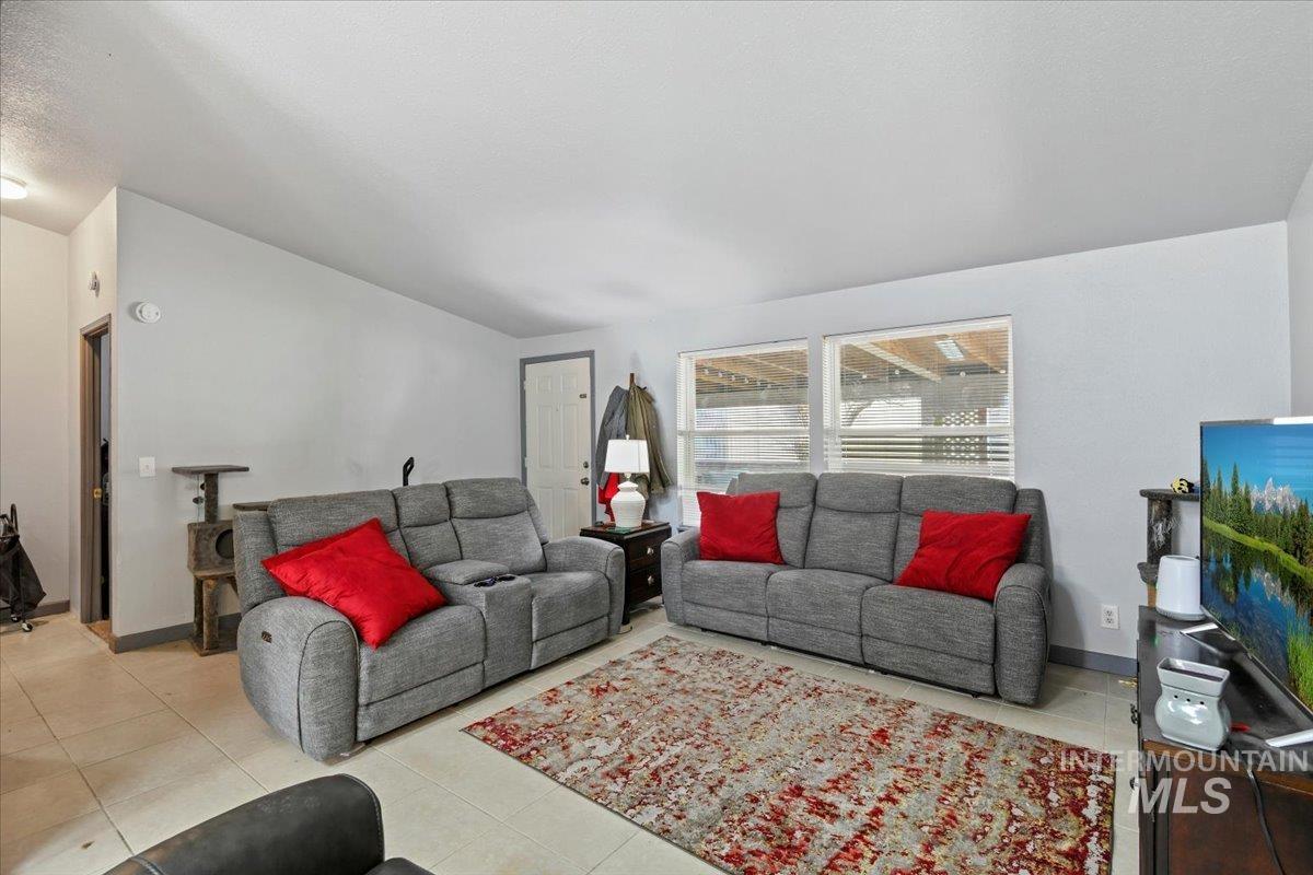 Living room featuring light tile patterned floors