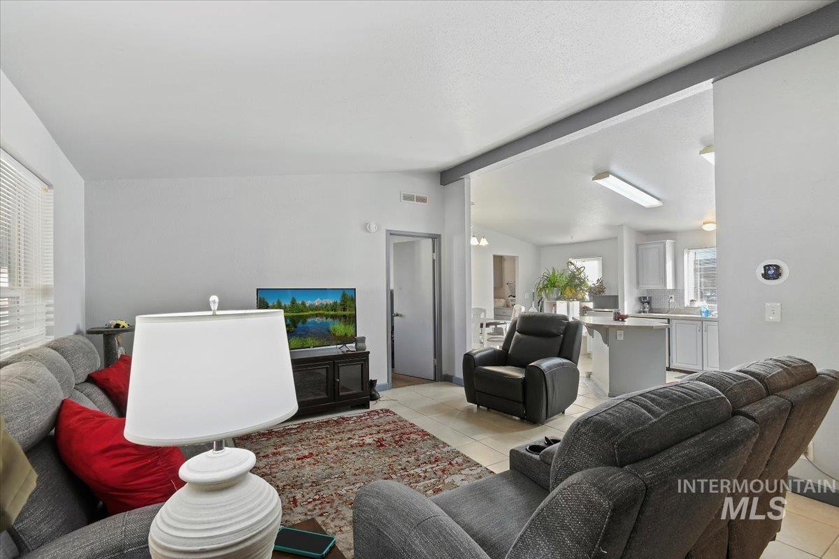 Living room with light tile patterned flooring