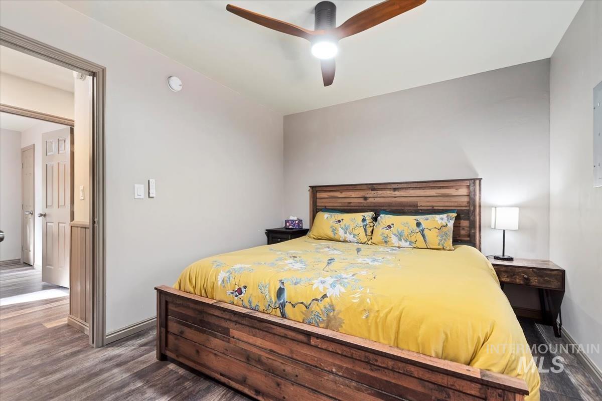 Bedroom with dark wood finished floors and ceiling fan