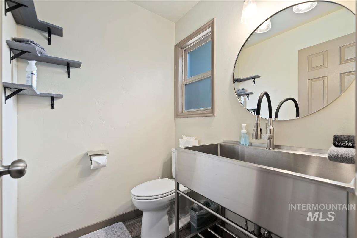 Half bathroom featuring toilet and baseboards