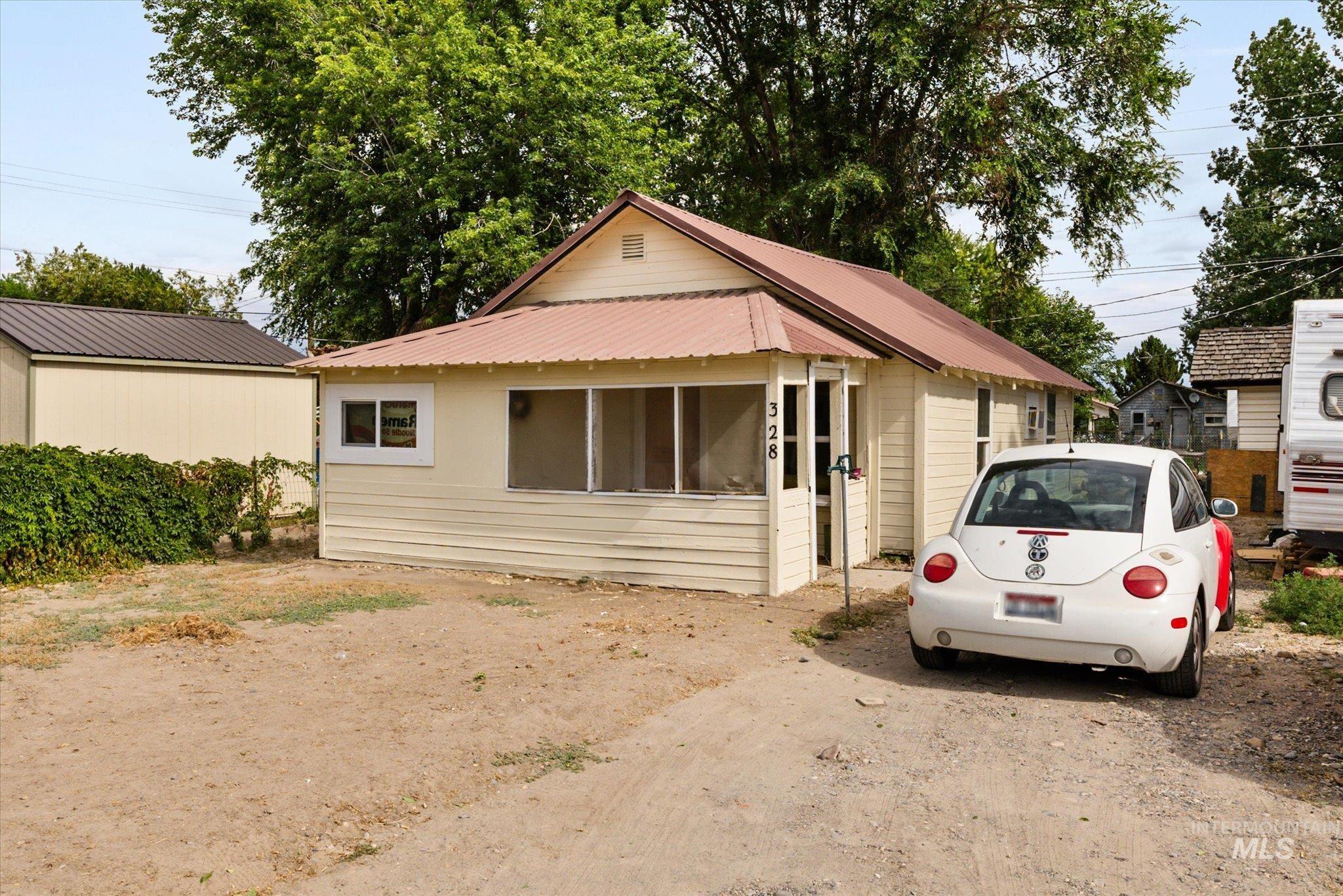 View of front of house with a metal roof