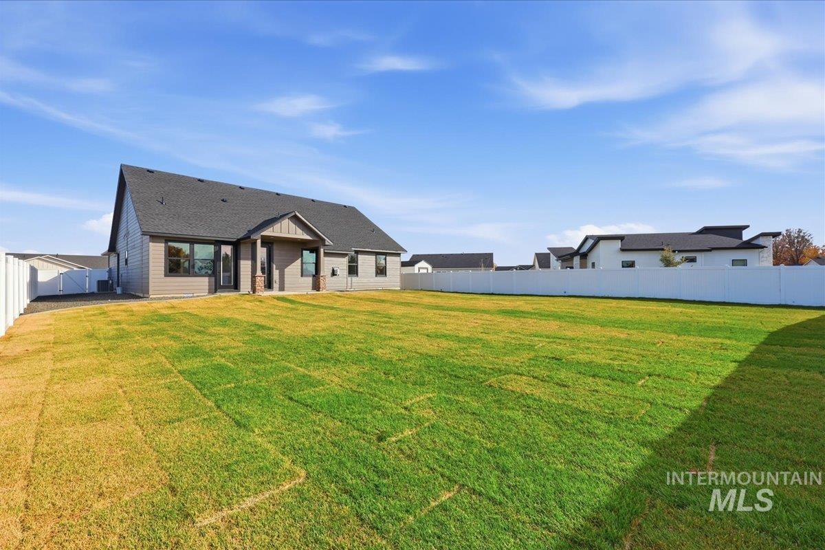 Rear view of property with a fenced backyard