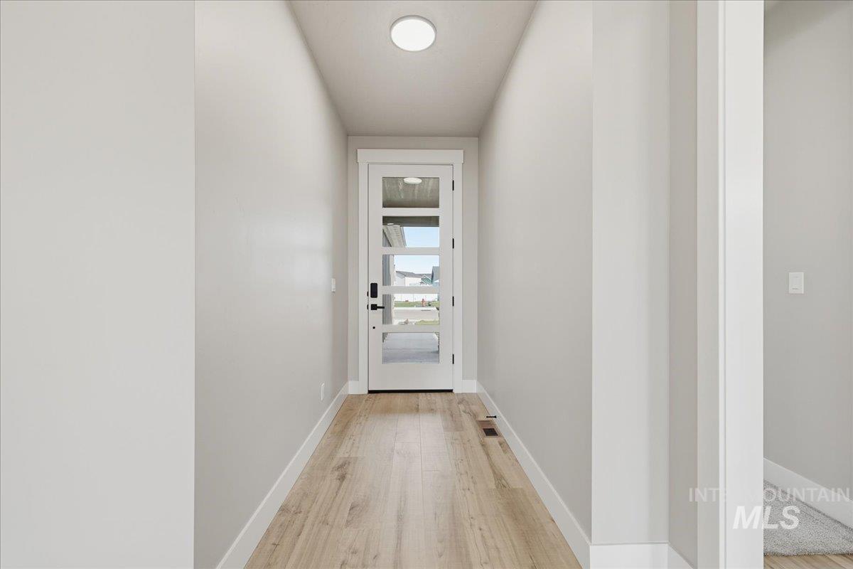 Entryway featuring wood finished floors and baseboards