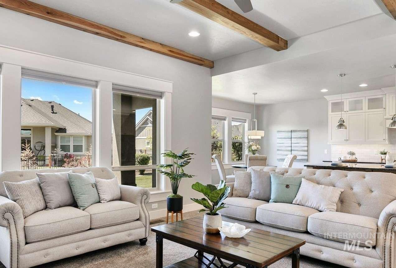 Living room featuring recessed lighting, beam ceiling, and wood finished floors