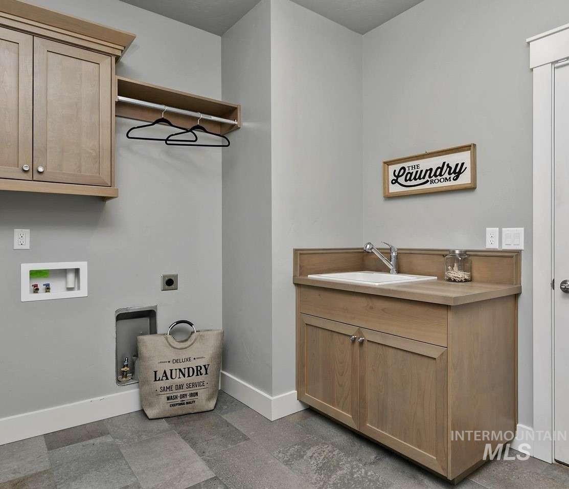 Laundry room with cabinet space, hookup for a washing machine, and hookup for an electric dryer