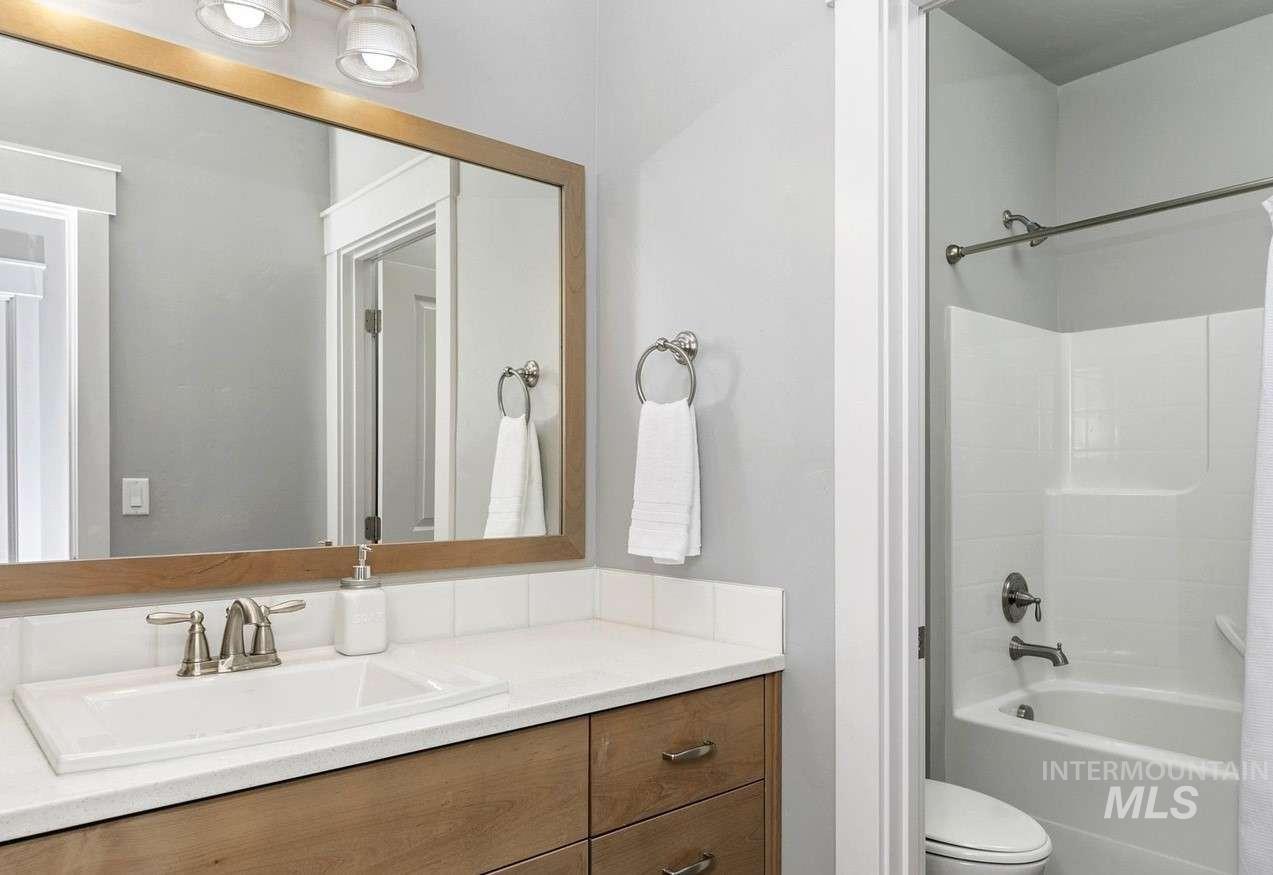 Bathroom with shower / tub combo and vanity