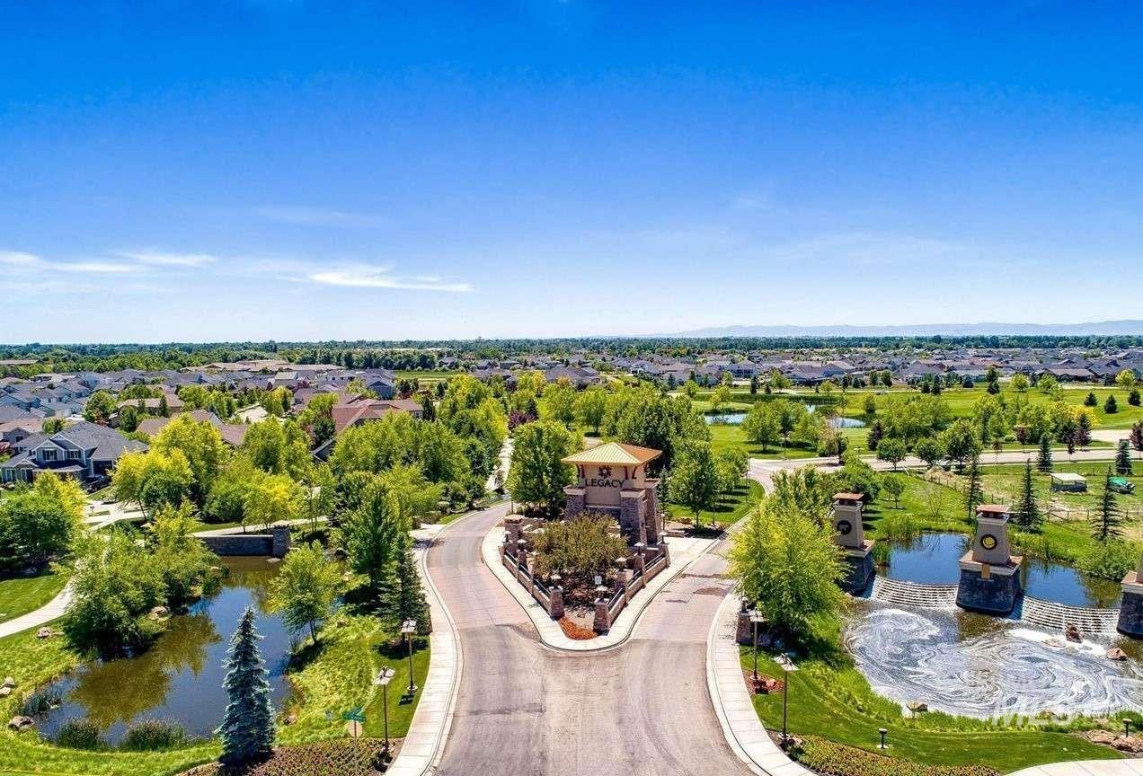 Aerial view of residential area featuring a nearby body of water