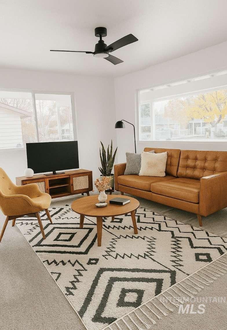 Living area with carpet floors and ceiling fan