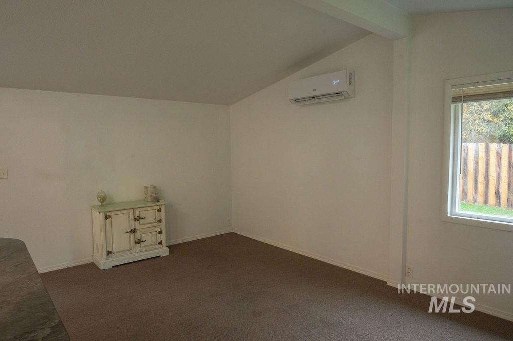 Walk through Bedroom, den, or office area carpet floors and a wall mounted air conditioner