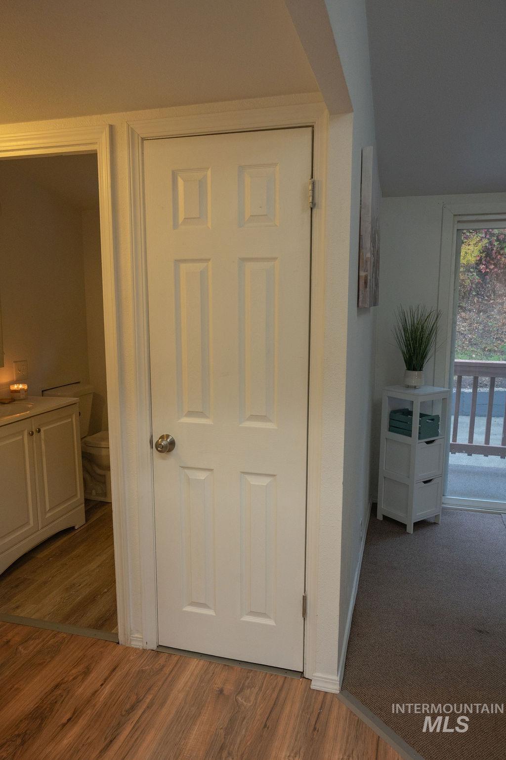 Hall with dark wood-style flooring