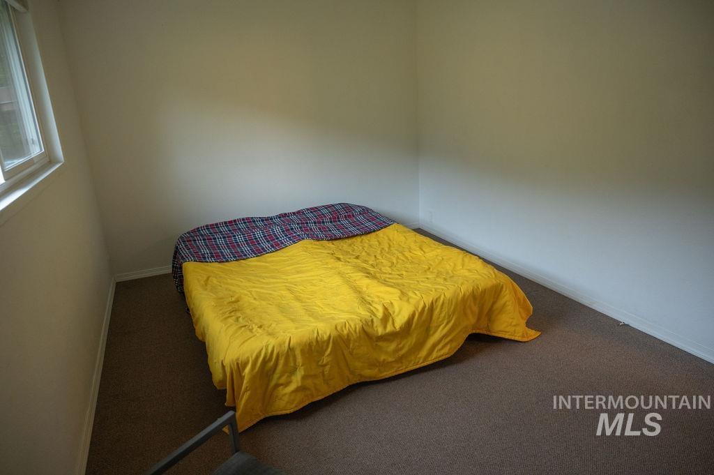 Carpeted bedroom with baseboards