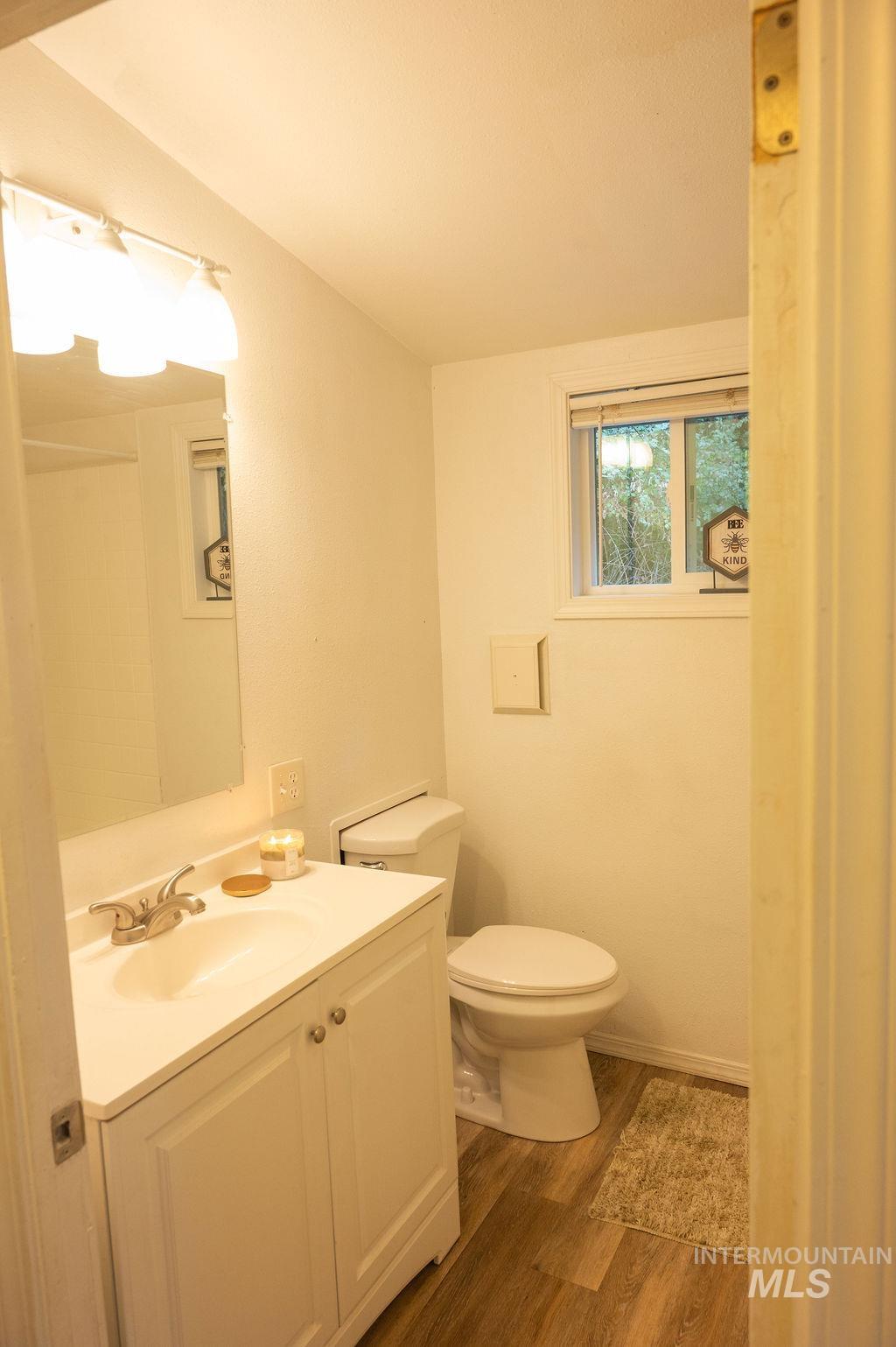 Bathroom with vanity and dark wood-style flooring