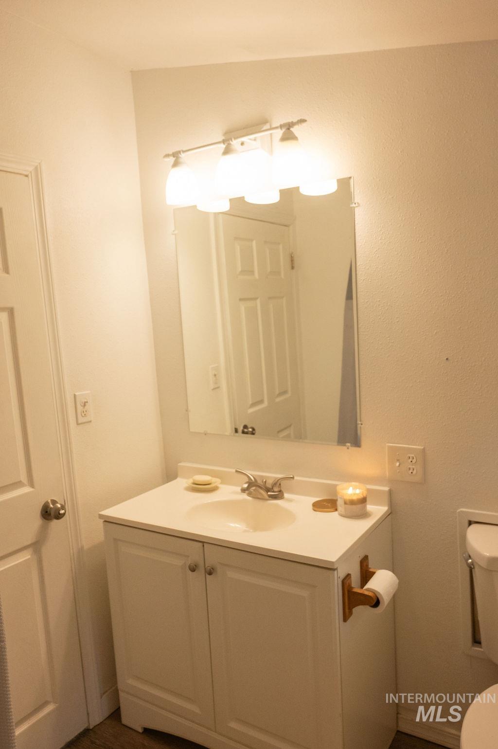 Bathroom featuring vanity and toilet