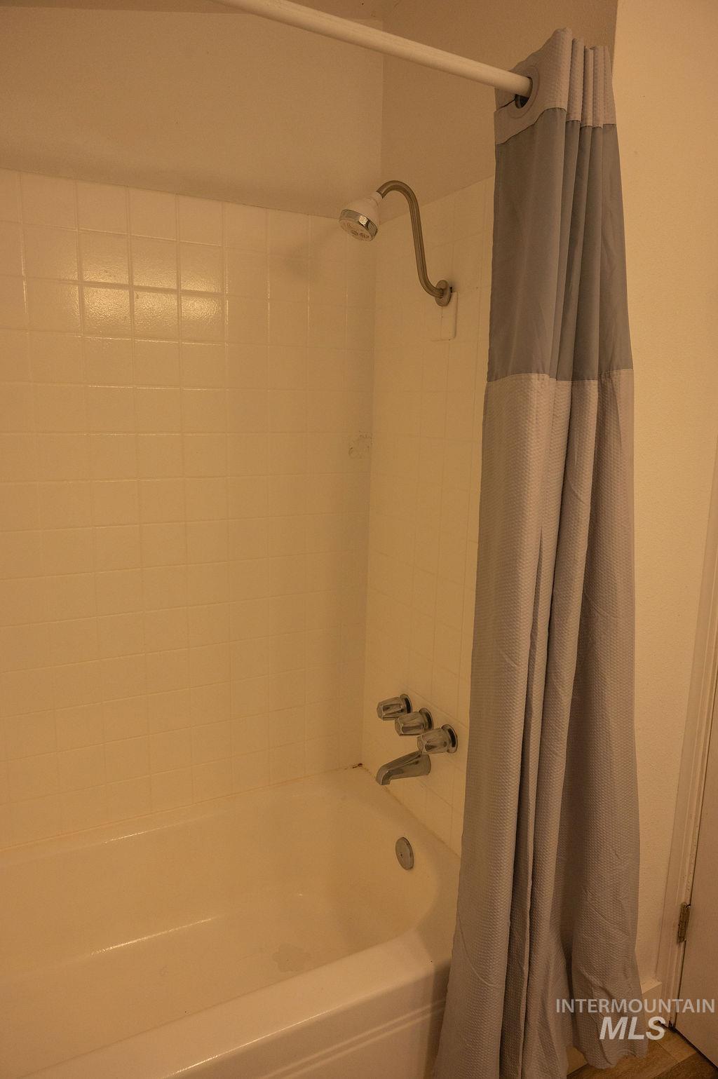 Bathroom featuring shower / bath combination with curtain