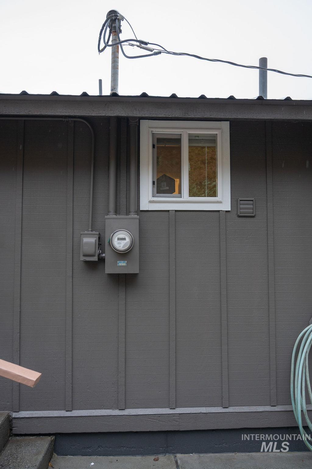 Exterior view of board and batten siding and electric meter