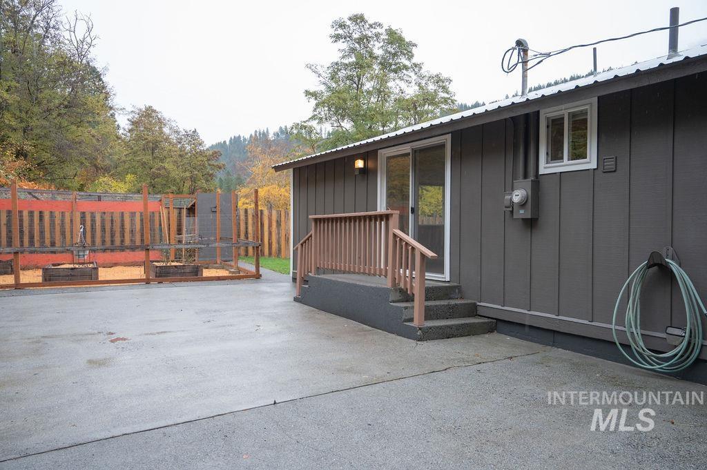 Entrance to property featuring a patio area and a metal roof