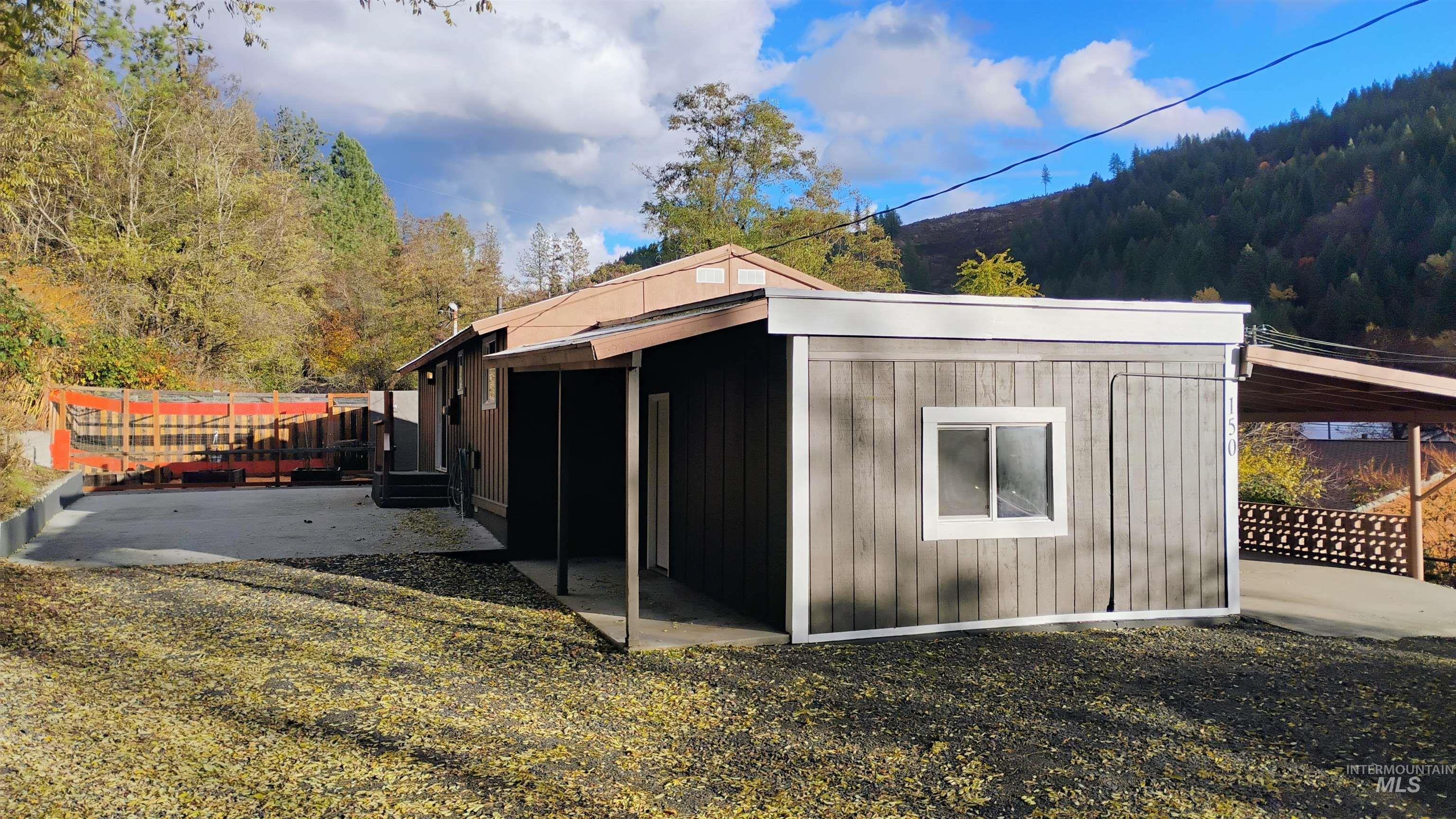 View of West side of the home featuring a view of trees