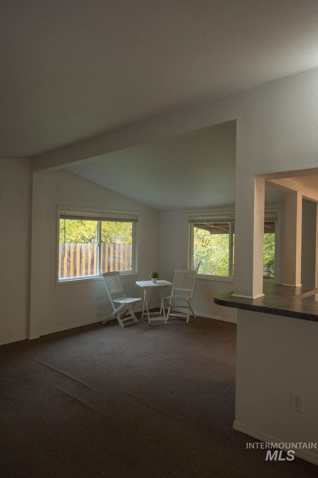 Living Room open to dining area and view of Garden and hillside.