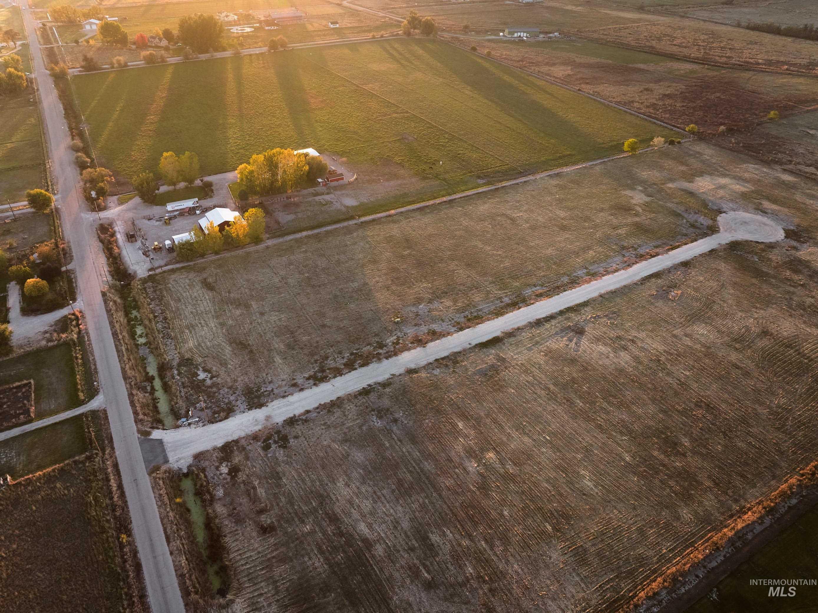 Aerial view of property and surrounding area with rural landscape and large plots for crops