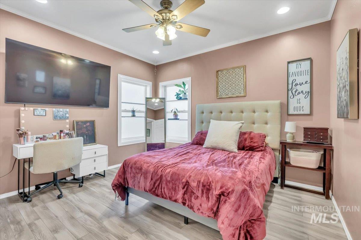 Bedroom with ornamental molding, recessed lighting, a ceiling fan, light wood finished floors, and an office area