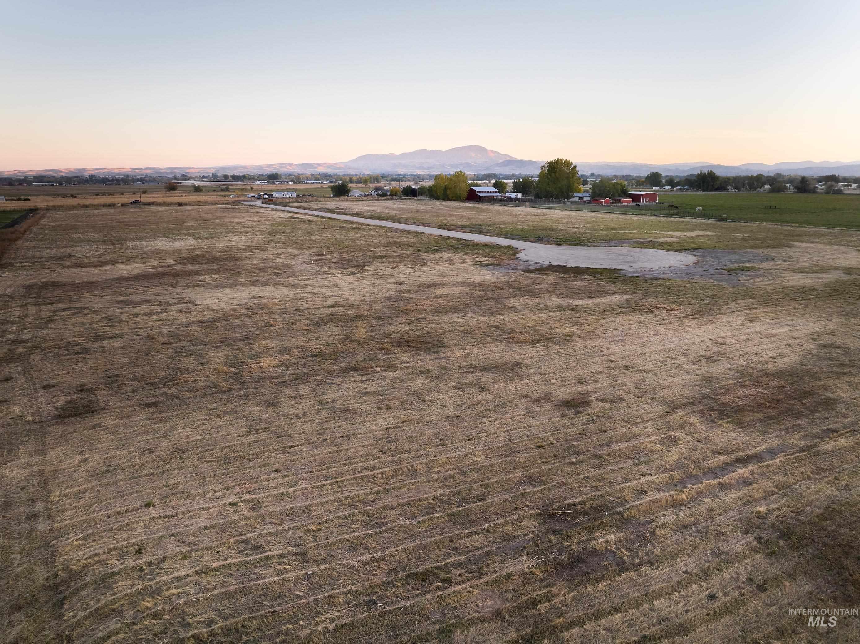 Aerial view at dusk of a mountain view and a view of rural / pastoral area