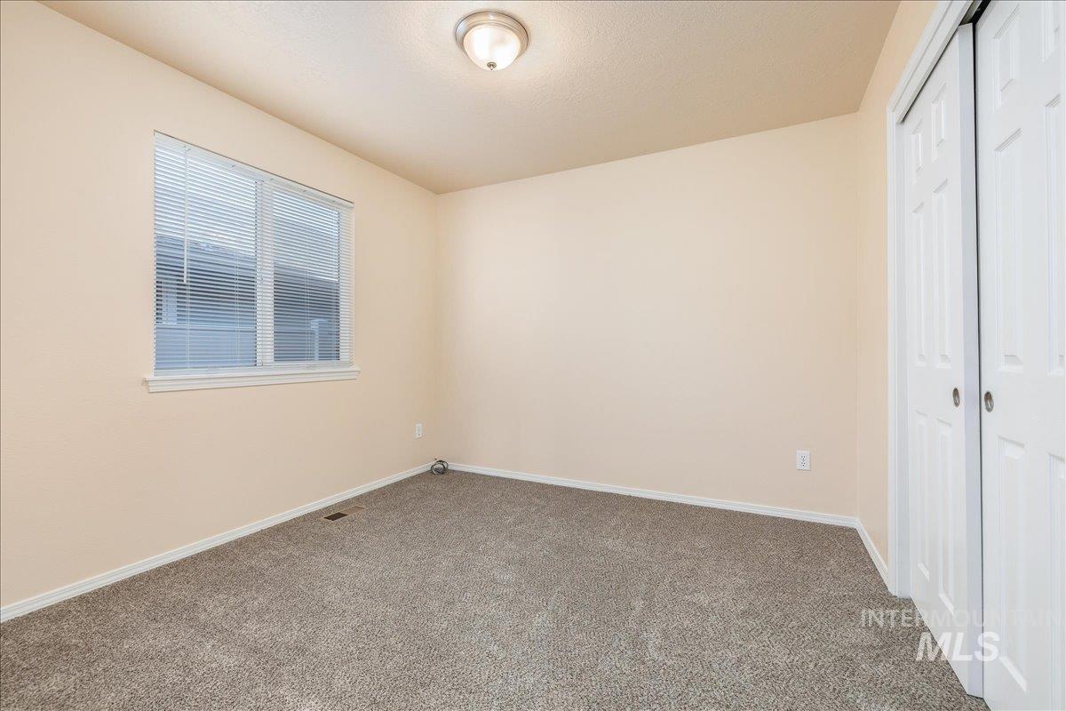 Unfurnished bedroom with a closet and carpet flooring