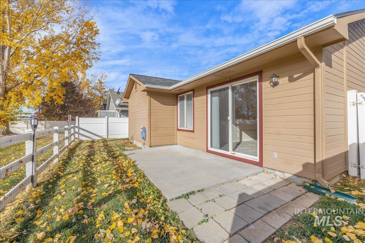 Back of property featuring a fenced backyard and a patio