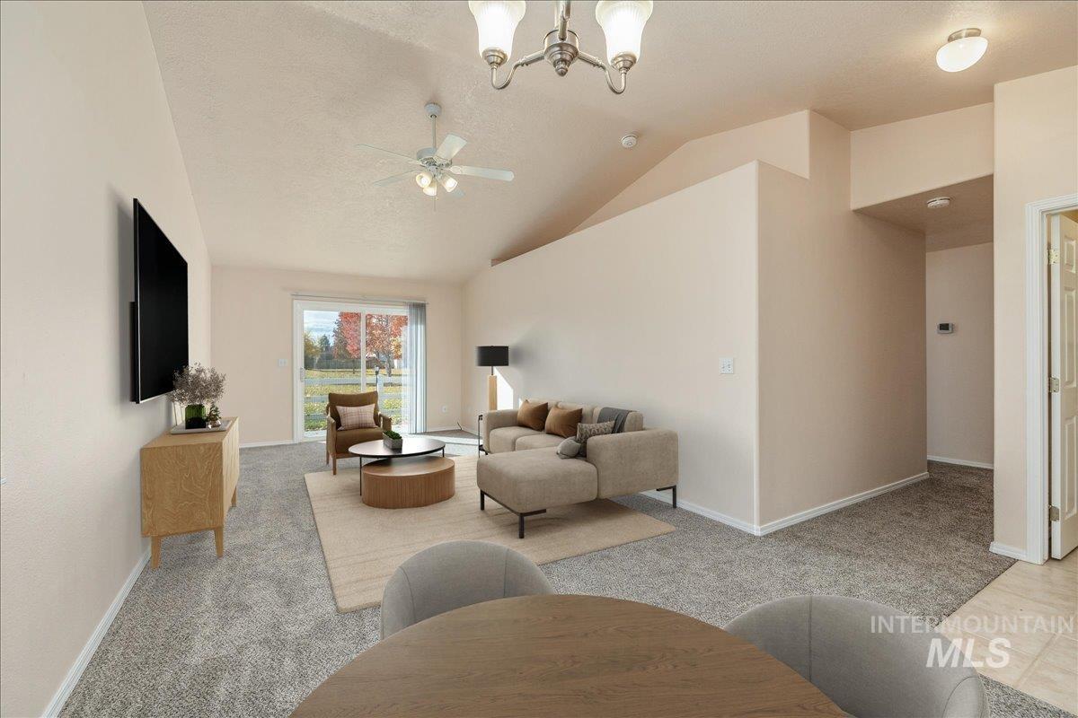 Living area featuring light colored carpet, lofted ceiling, a chandelier, a ceiling fan, and a textured ceiling