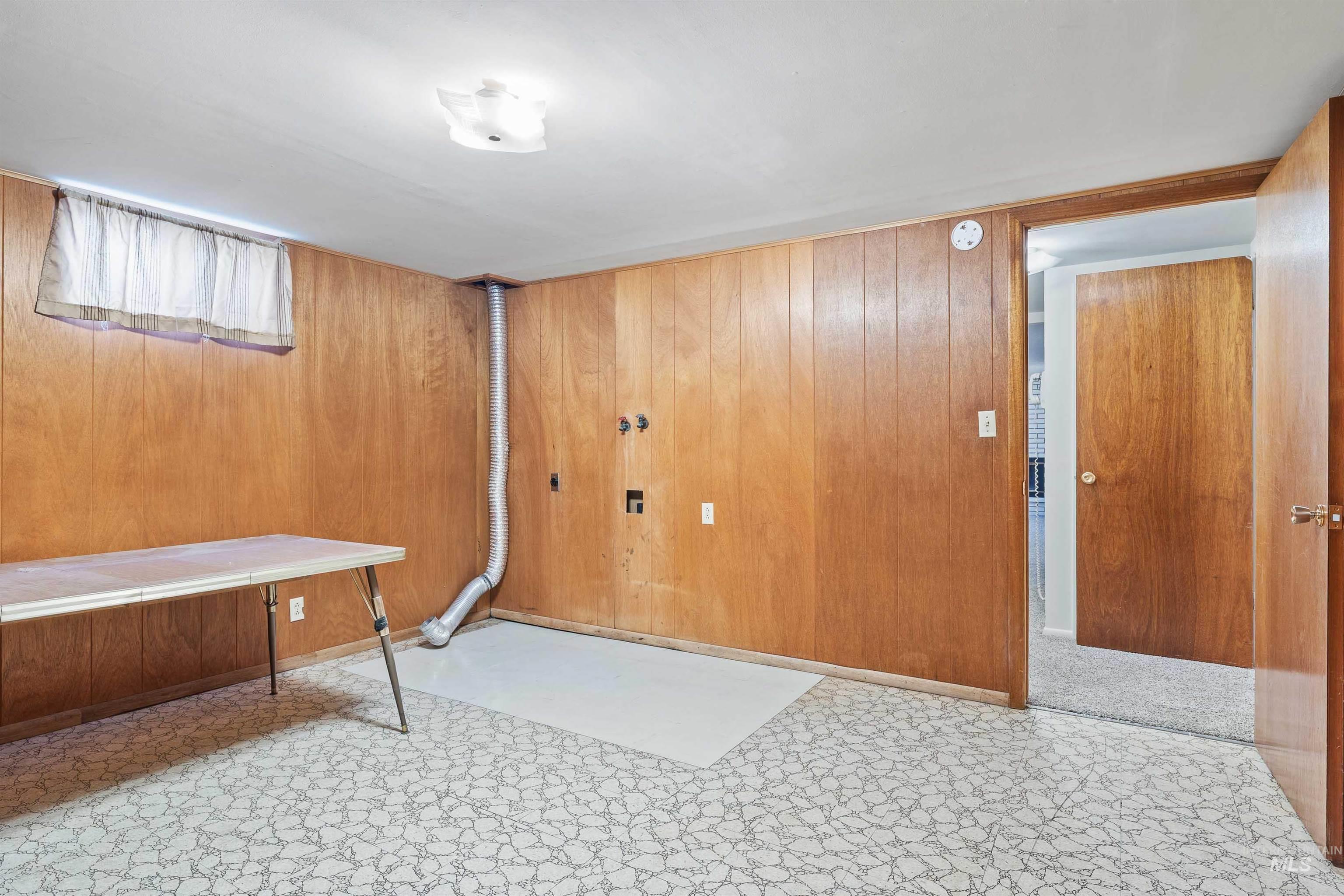Basement featuring wood walls