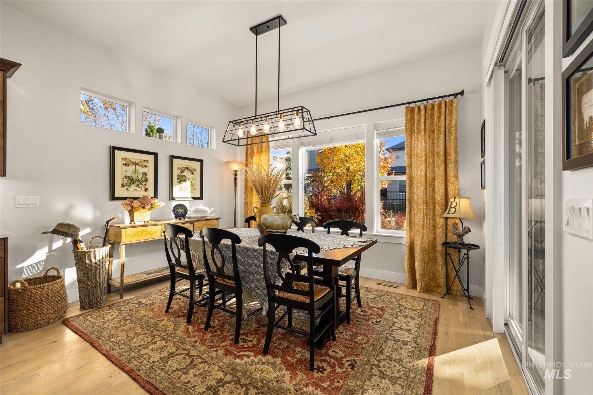Dining area with light wood-style flooring and baseboards