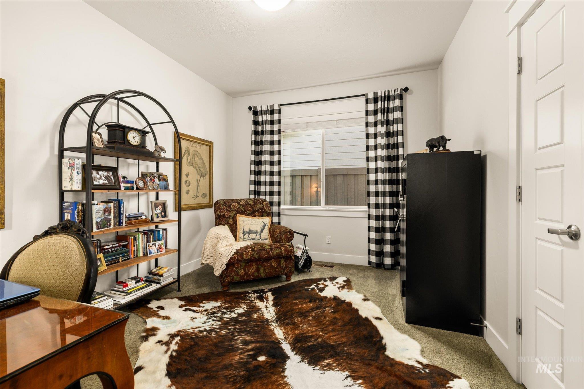 Sitting room with light carpet and baseboards