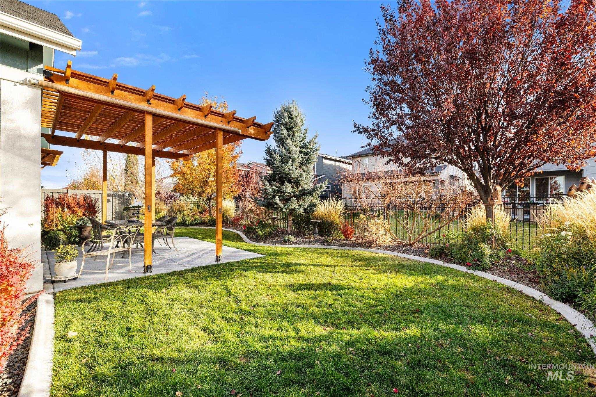 View of yard with a pergola and a patio area