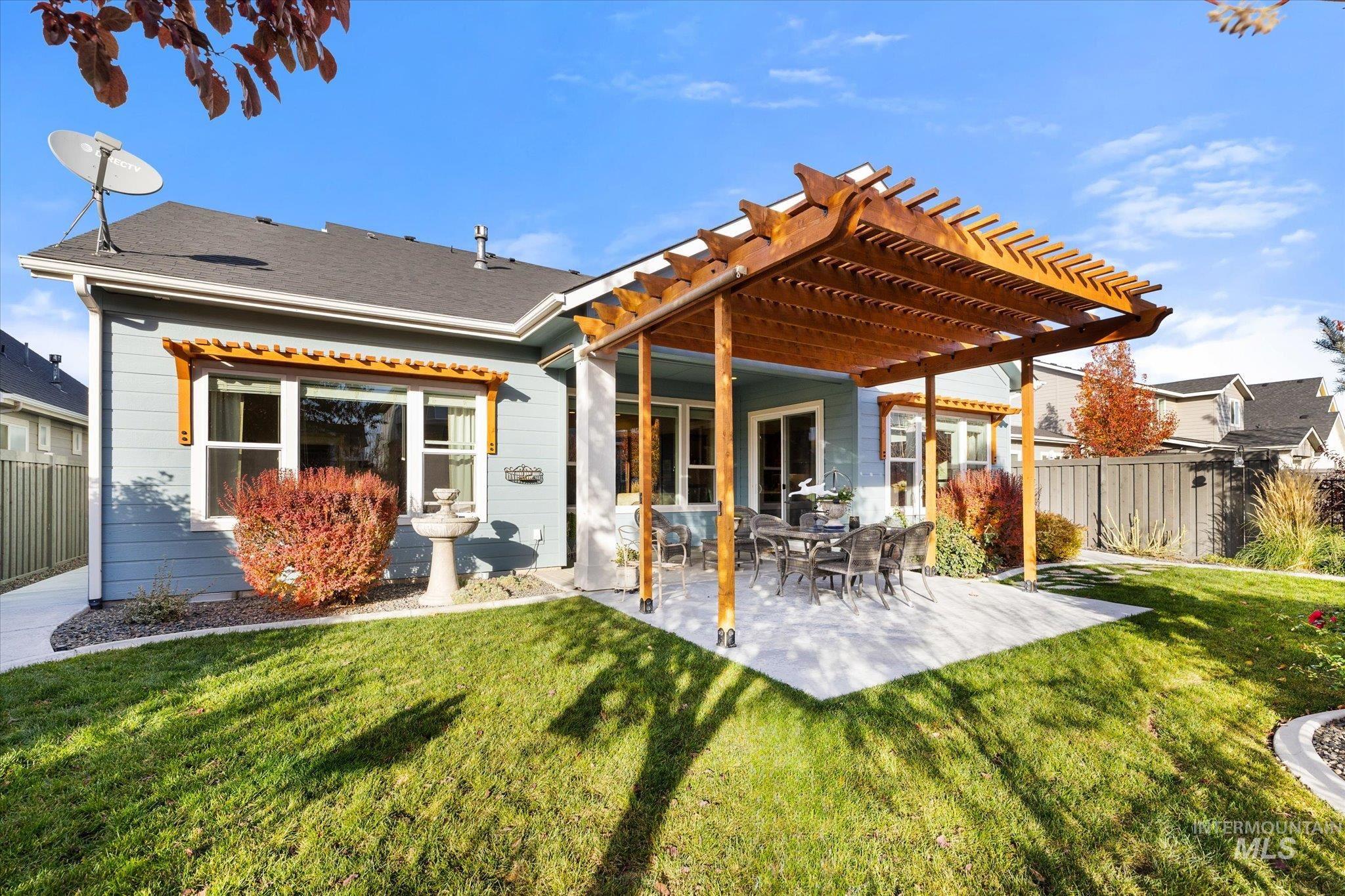 Rear view of house with a pergola and a patio area
