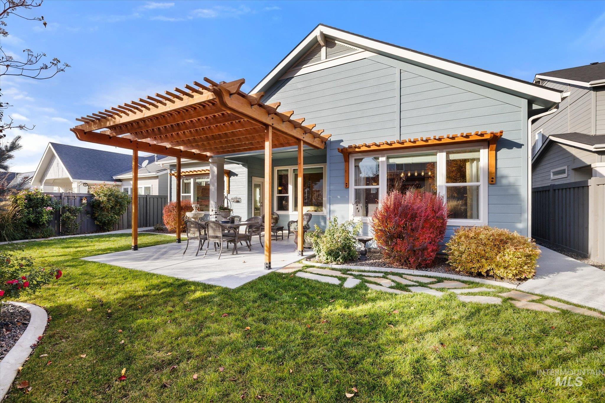 Back of property with a pergola and a patio area