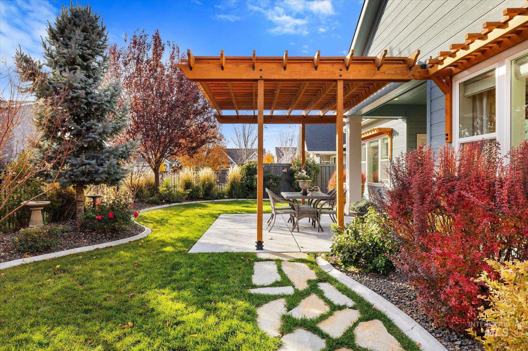 View of yard with a pergola and a patio