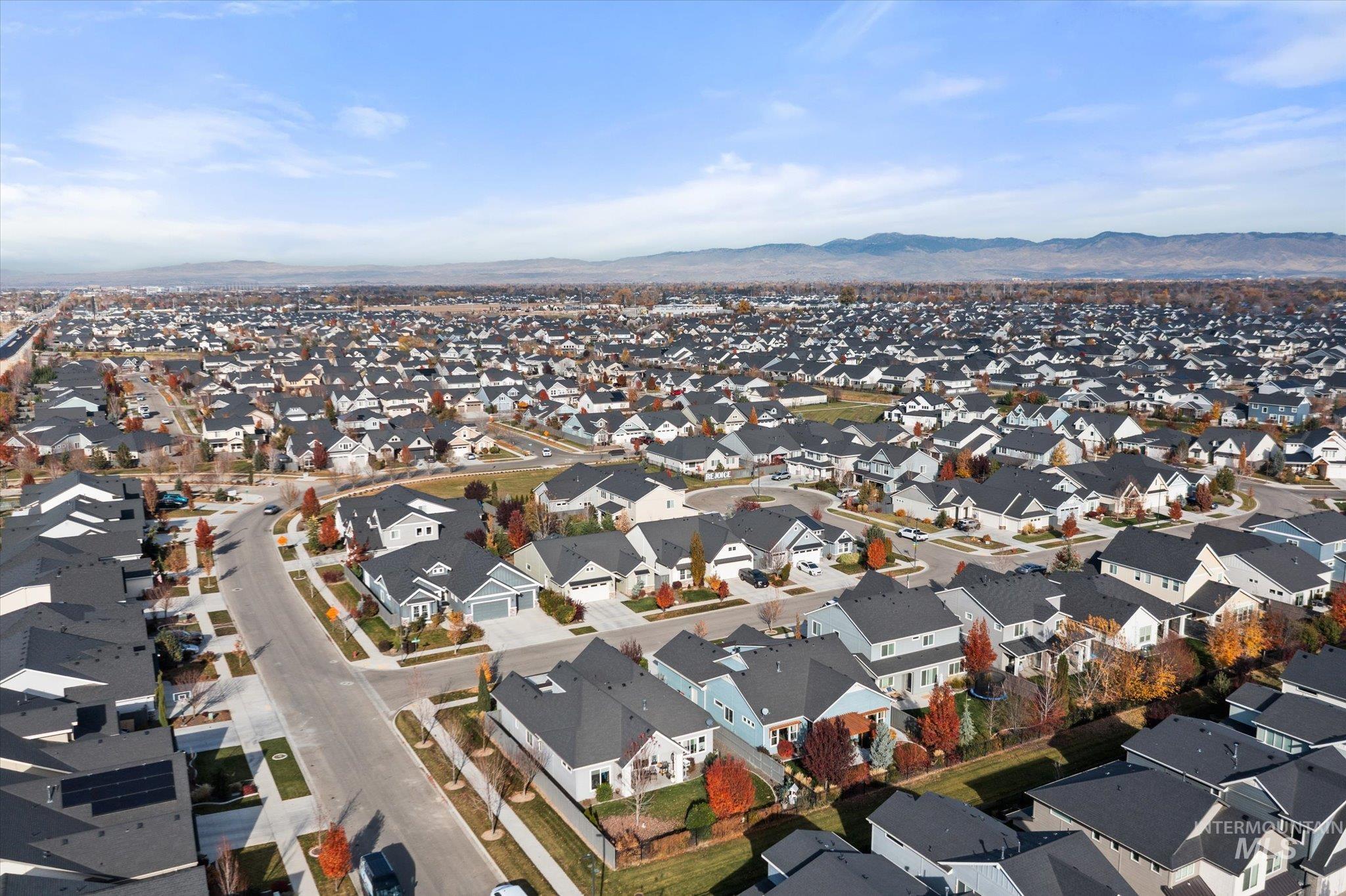 View of property location featuring mountains and nearby suburban area
