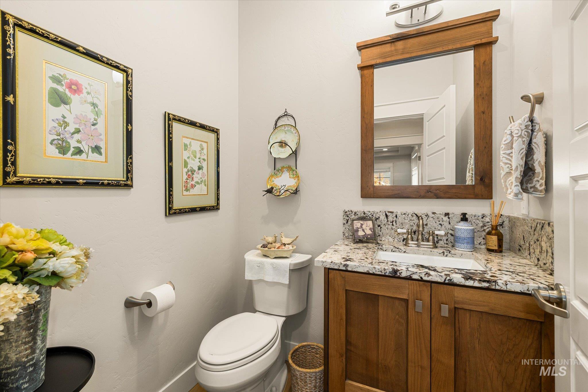 Half bath featuring vanity and toilet