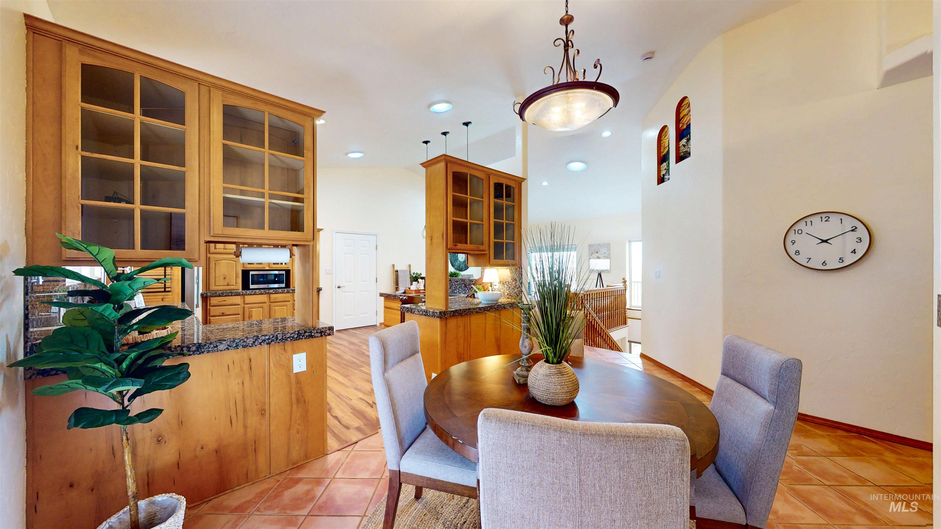 Dining room with light tile patterned flooring and recessed lighting