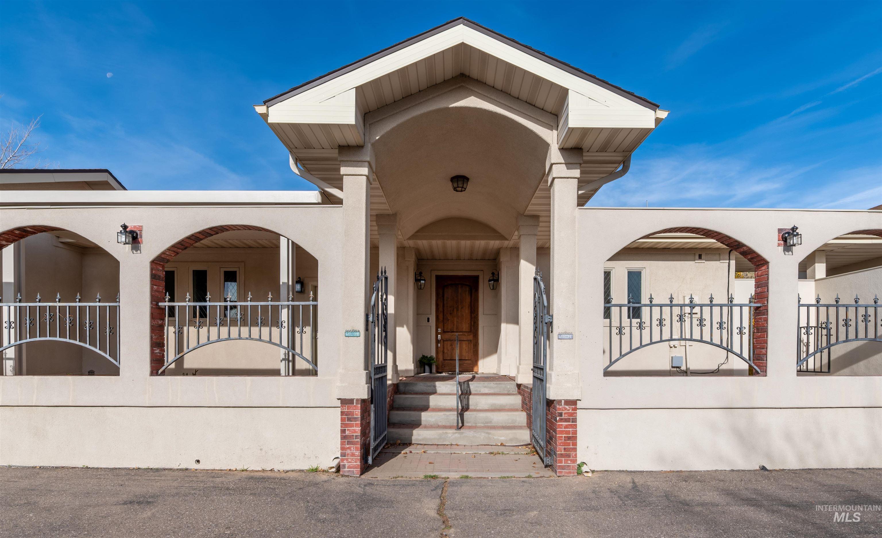 Doorway to property featuring stucco siding