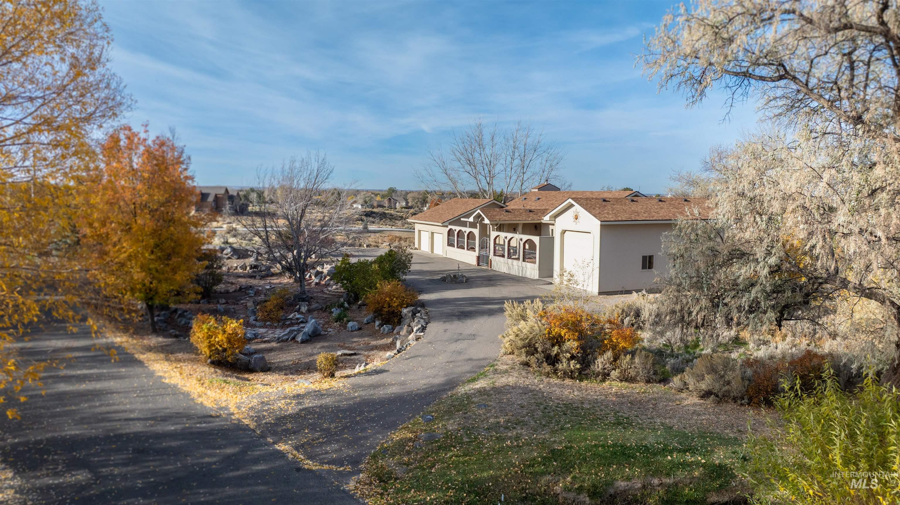 Ranch-style home with a garage, stucco siding, and driveway