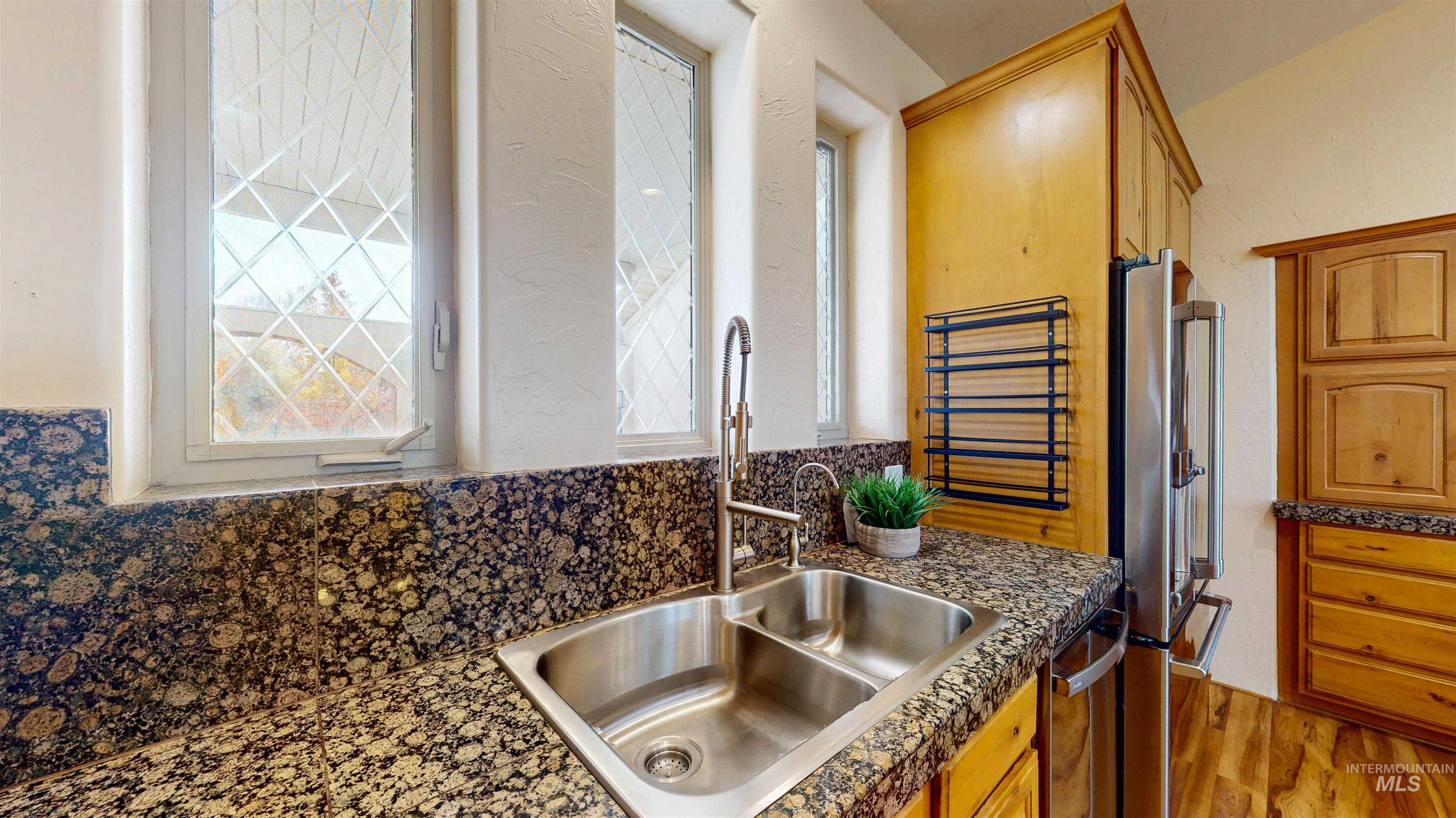 Kitchen featuring stainless steel appliances, light wood-type flooring, and brown cabinets